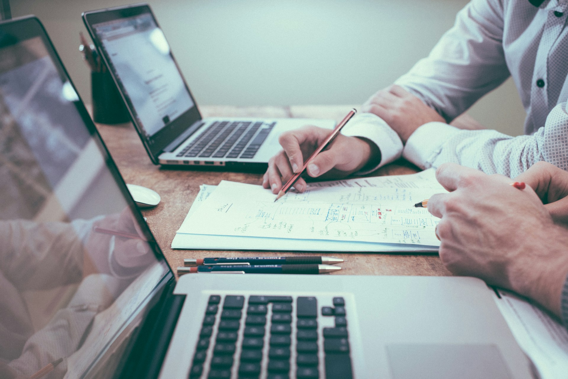 Two people reviewing a written plan together at a desk